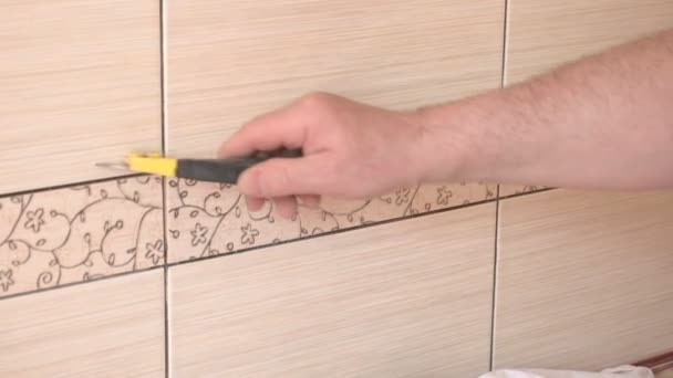 Man cleaning ceramic tiles in the kitchen — Stock Video