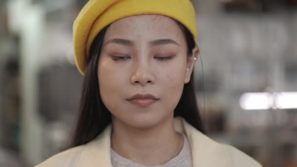 Portrait of charming asian woman in yellow hat — Stockvideo