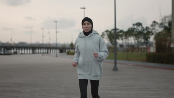Corredor musulmana en el hiyab haciendo ejercicio en la calle de la ciudad — Vídeos de Stock