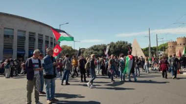 Rome, Italy, 5.10.2025: People gather in the streets near Piramide and Porta San Paolo during a pro-Palestine rally, waving Palestinian flags and showing solidarity and support.