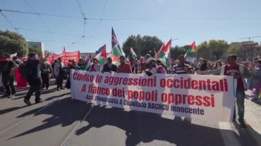 Rome, Italy, 5.10.2025: Demonstrators march with a banner reading Contro le aggressioni occidentali - standing in solidarity with oppressed peoples during a pro-Palestine rally.