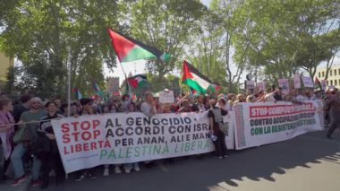 Rome, Italy, 5.10.2025: Protesters hold large banners and Palestinian flags during a march in Rome, calling for justice, freedom, and an end to the conflict.