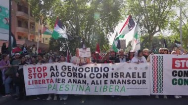 Rome, Italy, 5.10.2025: Demonstrators march through the streets of Rome holding Palestinian flags and large banners calling for freedom and justice during a solidarity protest.