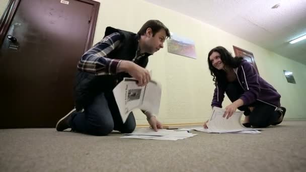 Man and woman raising documents from the hall — Stock Video