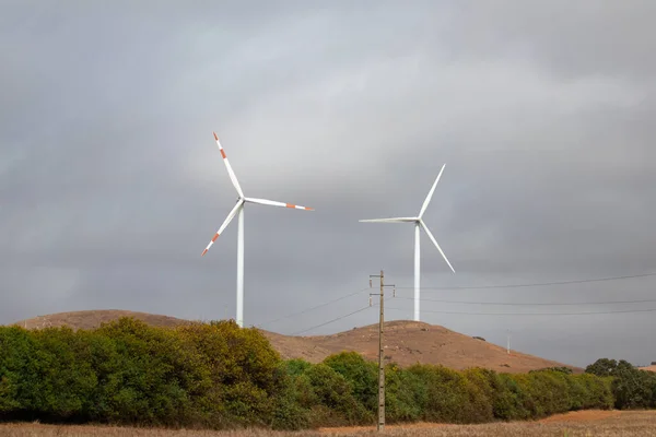 Couple windmills in a rural field in Alentejo.