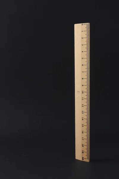 Wooden ruler isolated on a black background — Stock Photo, Image