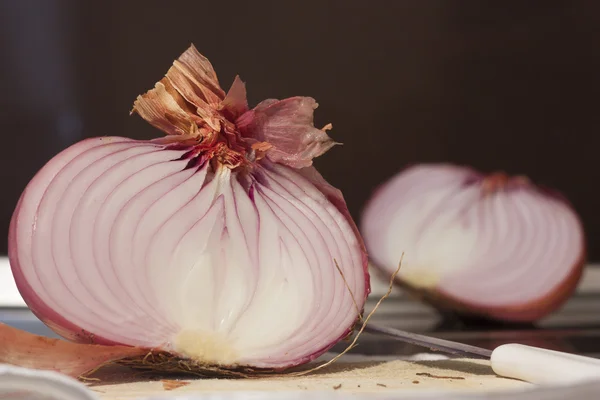 Red sliced onion isolated on black background