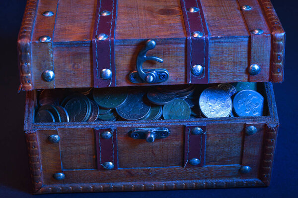 Деревянный сундук с сокровищами, биткойнами, монетами или долларами на тёмном фоне