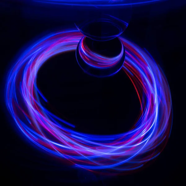 Painting with light on a mirror with small colored lamps and a glass ball.