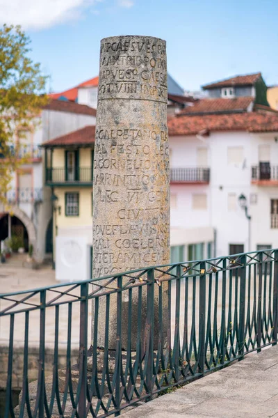 Chaves, Portugal. August 21, 2020. Roman inscription on a column. Touristic and historic landmark, stone roman bridge on the Tamega river. Also known as Trajan\'s bridge (Ponte de Trajano).