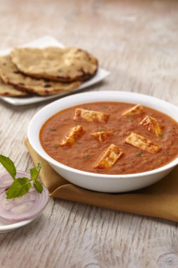 Paneer Tikka Masala curry with roti clipart
