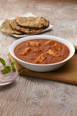 Paneer Tikka Masala curry with roti clipart