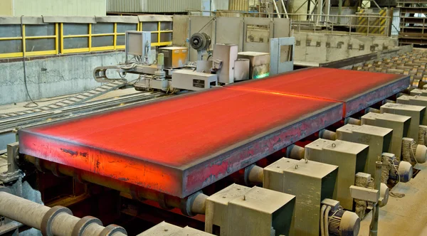 Hot steel on conveyor — Stock Photo, Image