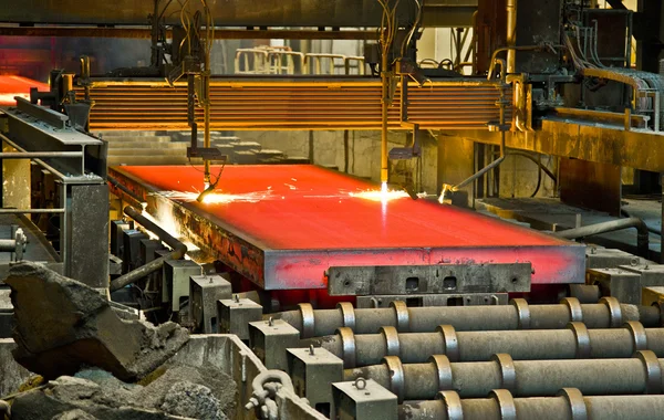 Hot steel on conveyor — Stock Photo, Image