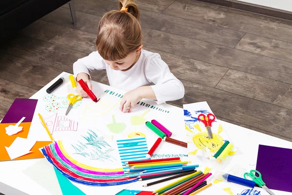 beautiful little girl draws felt-tip pens