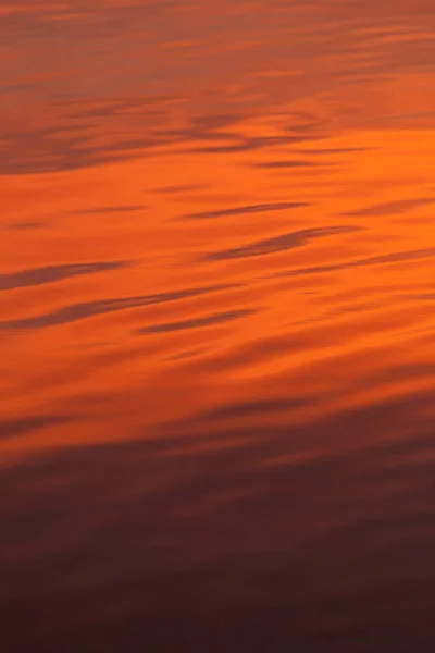 red reflection in water, metallic red water, abstract background