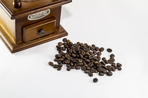 Grinder and a handful of coffee beans — Stock Photo, Image