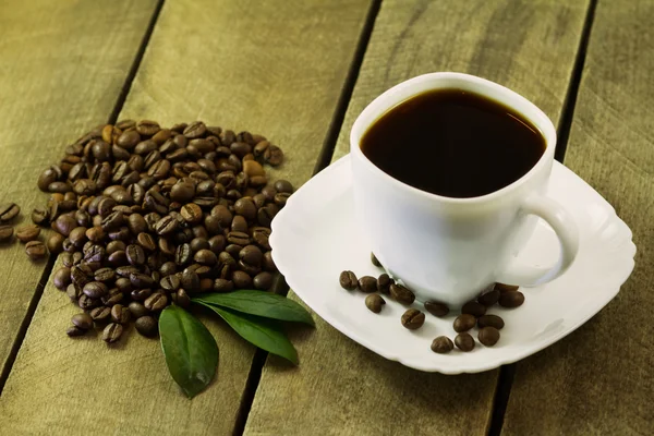 Black coffee in white cup and coffee beans — Stock Photo, Image