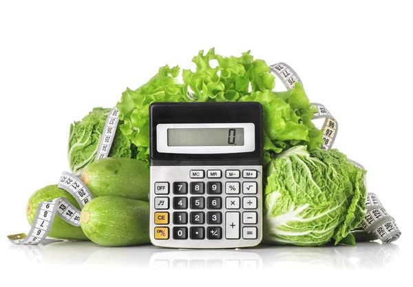 Green vegetables, calculator and centimeter isolated on a white — Stock Photo, Image