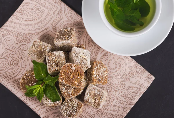 Raw food candy on a beautiful background with mint tea in a whit — Stock Photo, Image