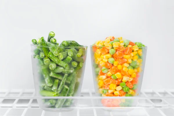 Frozen green beans, corn green peas and chopped carrots  in a gl