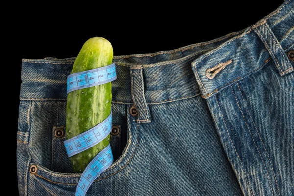 Big cucumber like the penis in the mens jeans, centimeter — Stock Photo, Image