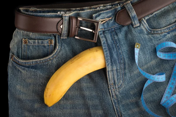 Big Banana like the penis, centimeter and men's jeans — Stock Photo, Image