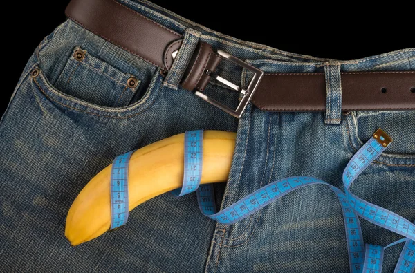 Big Banana like the penis, centimeter and men's jeans — Stock Photo, Image