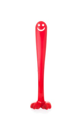 Red plastic shoehorn or shoespoon with a smiling face like a big penis clipart