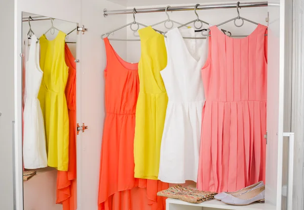 Bright colorful dress hanging on coat hanger — Stock Photo, Image