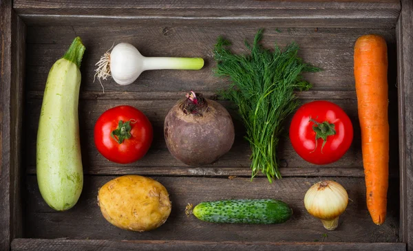 Set of different fresh raw vegetables in an old wooden box — 스톡 사진