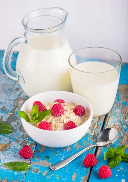 Oat flakes with milk and raspberries for breakfast