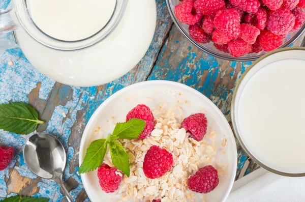 Oat flakes with milk and raspberries — Stock Photo, Image