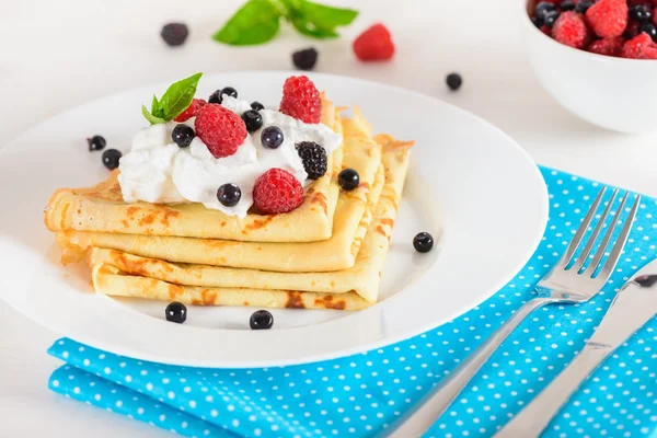 Delicious sweet crepes decorated air-cream and ripe berries — Stock Photo, Image