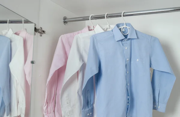 Wit, blauw en roze schoon gestreken mannen shirts — Stockfoto