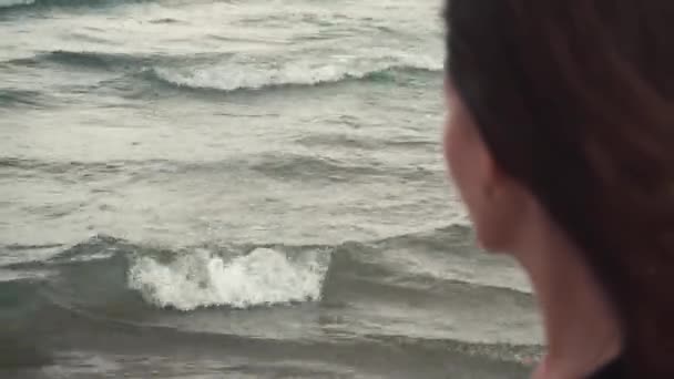 Woman looks on far sea surface — Stock Video