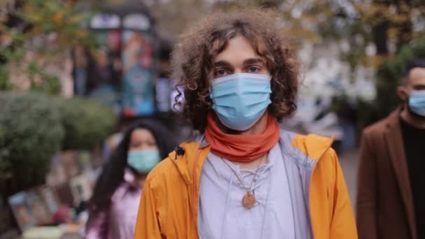 Πολυπολιτισμικοί άνθρωποι που στέκονται στο δρόμο με ιατρικές μάσκες — Αρχείο Βίντεο