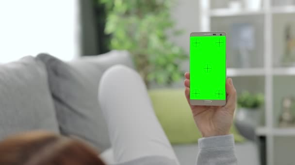 Woman tapping on green screen of smartphone — Stock Video