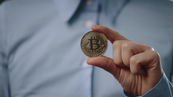 Close up of man showing glowing bitcoin sign — Stock Video