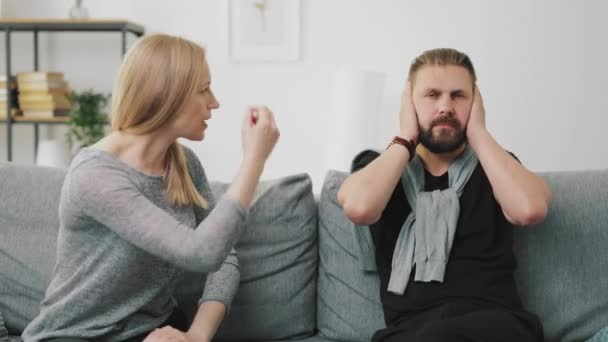 Man ignoring berating wife — Stock Video