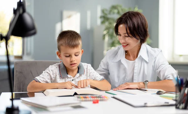 Boy reading book with mother — Stock Photo, Image