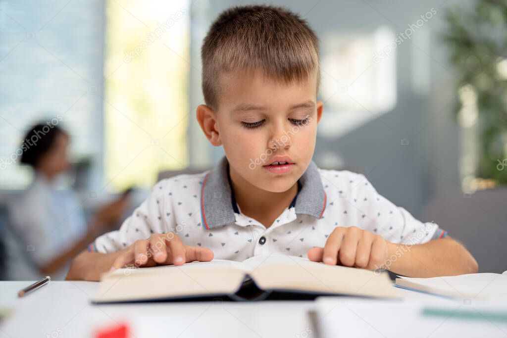 Boy reading book at home
