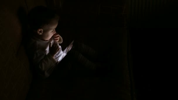 Boy browsing tablet pc in the dark — Stock Video