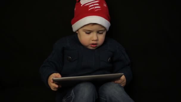 Little boy have fun holding a tablet pc — Stock Video