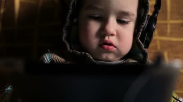 Little boy with headphones browse tablet pc — Stock Video