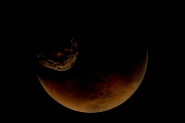 İki uydudan biri olan Phobos 'un yüksek çözünürlüklü görüntüsü. Bu çarpıcı görüntü düzensiz şeklini, derin kraterlerini ve uzayın karanlığına karşı yakalanmış engebeli yüzeyini gözler önüne seriyor.. 