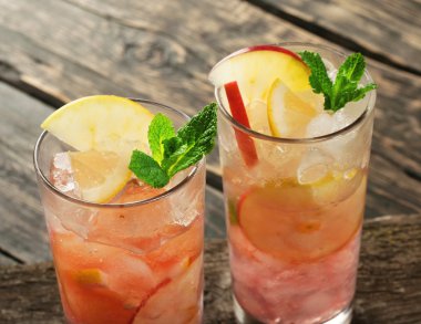 Two summer cocktail with ice, mint, apple and lemon clipart