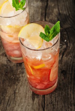 Cranberry cocktail with ice, mint, lemon and apple clipart