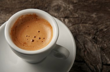 Closeup cup of coffee espresso with foam clipart