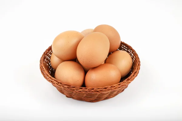 Hele bruine eieren in een rieten mand — Stockfoto